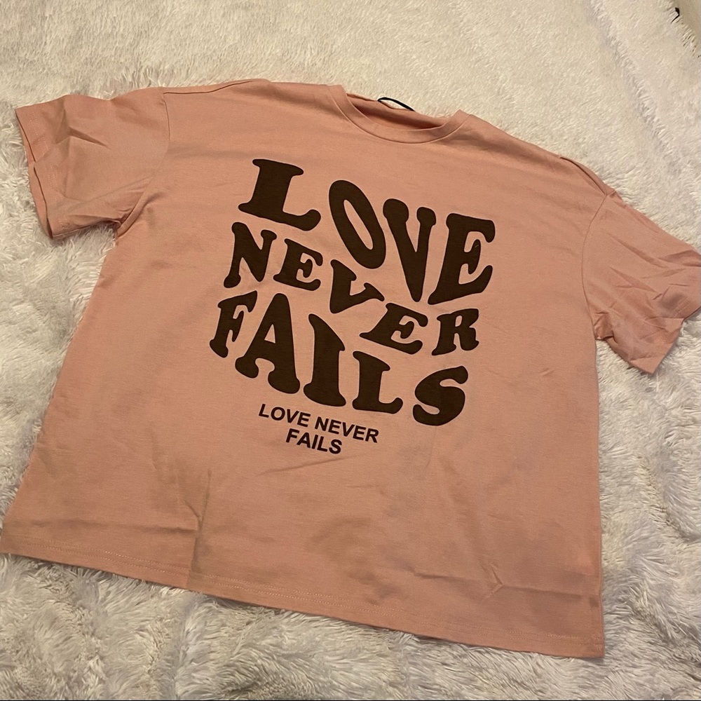 Love Never Fails Groovy Wave Font oversized shirt. Color coral/dusty rose. cute
